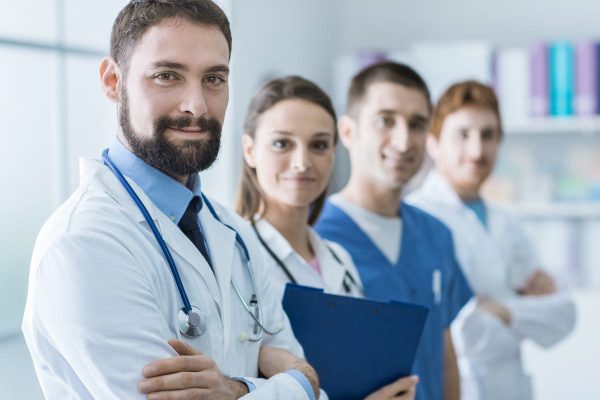 A group of healthcare professionals posing for the camera, who serve as the Institional Review Board (IRB).
