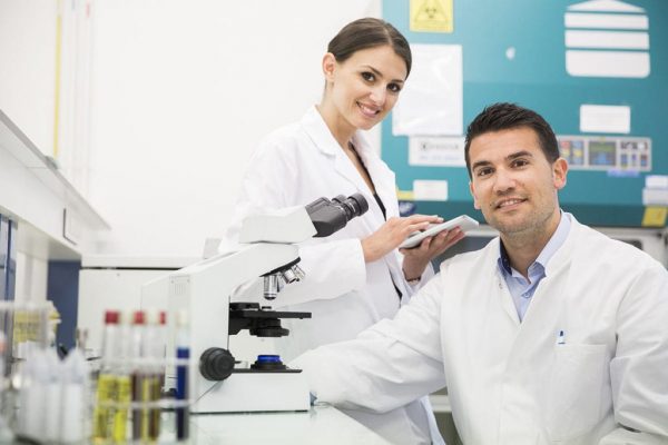 A male and female clinical research worker.