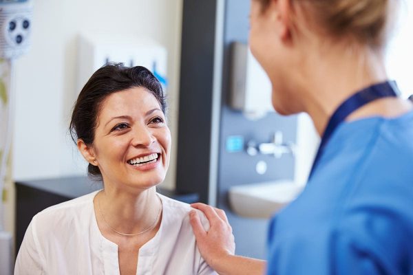 Woman talking with nurse while participating in a clinical research study. ato Rocky Mountain Clinical Research.